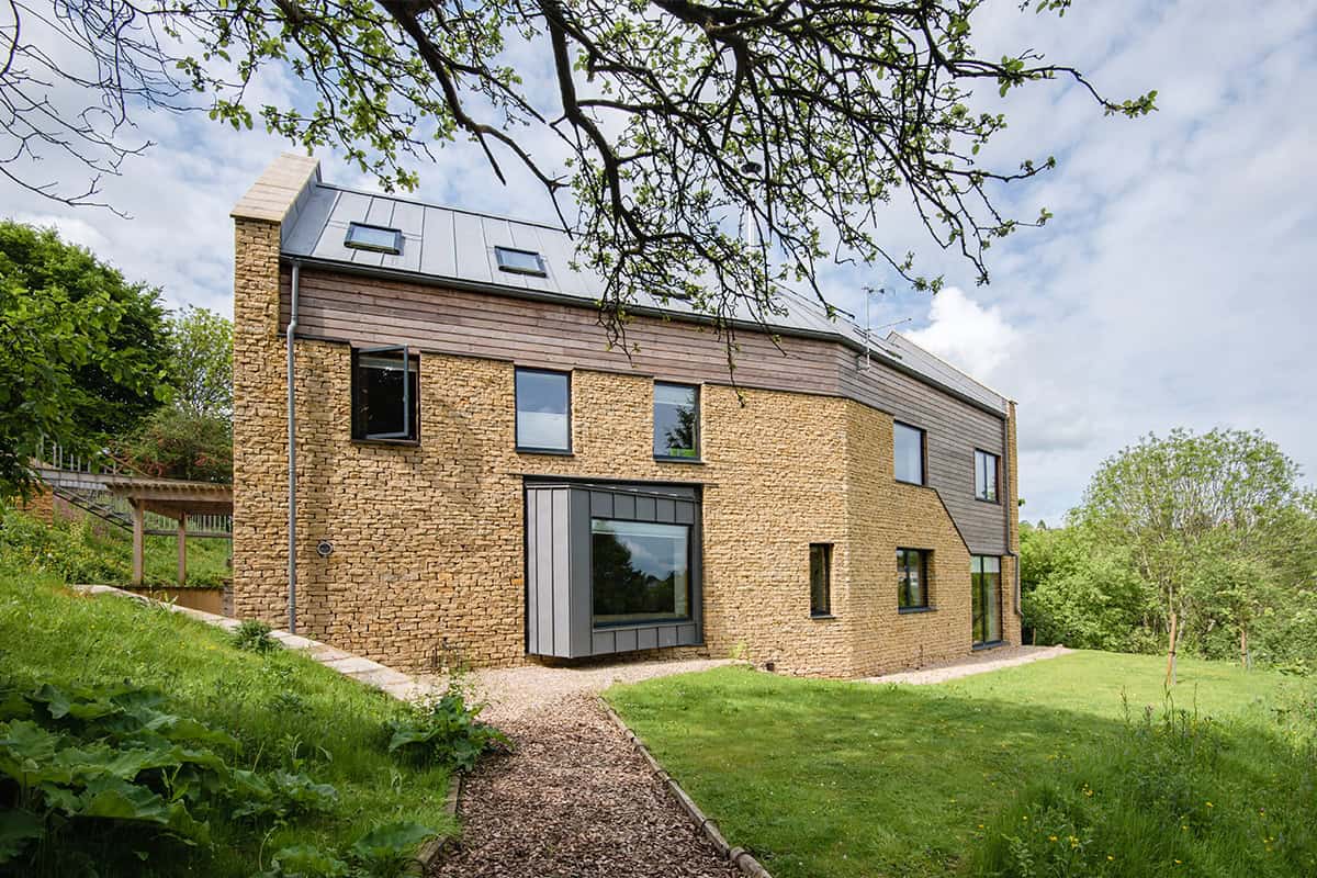 Harleywood House rear elevation with timber cladding, stone walls and garden path